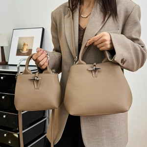 Elephant grey textured leather bucket bag with bamboo buckle shown in two sizes