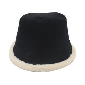 Black corduroy bucket hat with white faux fur trim on a white background