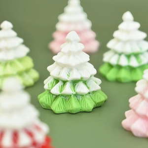 Close-up of a miniature green resin Christmas tree figurine for DIY crafts and micro landscapes