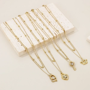 Gold titanium steel heart and crown necklaces with sparkling crystals on stone base