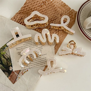 7-piece set of pearlescent white acetate hair claws in various elegant geometric shapes