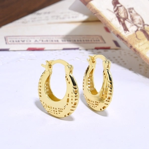 Close-up of gold-plated hollow hoop earrings featuring intricate retro lace patterns
