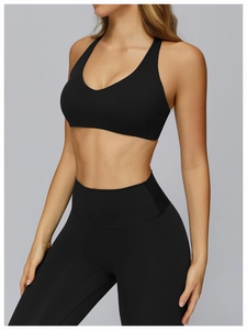 Detail of black V-neck sports bra and high-waisted leggings in matte high-elastic fabric