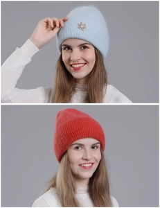 Detail of light blue and red knitted rabbit fur hats with metal leaf accessories