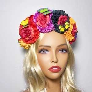 Detail of Day of the Dead headband with colorful faux flowers and butterfly decorations