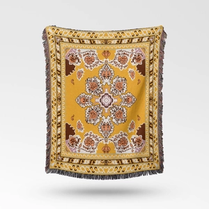 Close-up of bohemian woven blanket with mustard yellow mandala pattern and fringed edges