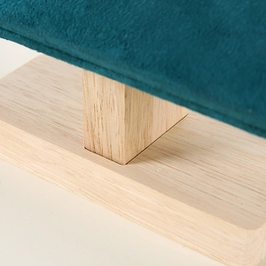 Close-up of wooden jewelry display stand base with premium turquoise velvet padding