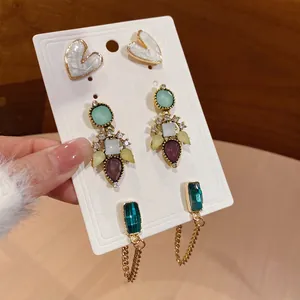 Three-pair vintage earring set featuring resin hearts, gem clusters, and emerald-cut drops