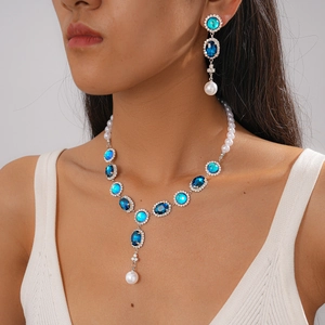 Macro detail of vintage necklace and earrings set with blue crystals and pearls