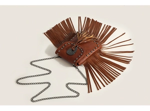 Detail of brown faux leather crossbody bag with metal rivets and long fringe tassels