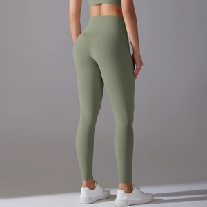 Detail of high waisted yoga leggings in olive green showing the seamless butt lifting cut
