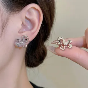 Hollow horse stud earrings in silver with black gemstone accents for a minimalist look