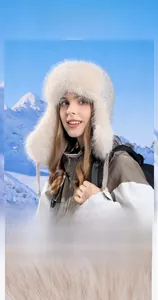 Detail of winter faux fur earflap hat with sequins on snowy mountain background