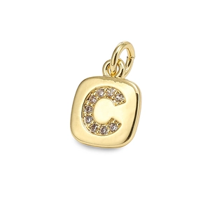 Close-up of golden square letter C pendant with micro-set zircon on white background