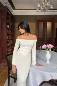 Detailed texture of white off-the-shoulder knit top and matching maxi skirt set