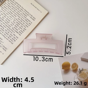 Detail of a pink matte shark hair clip showing dimensions of 10.3cm in length and 5.2cm in height