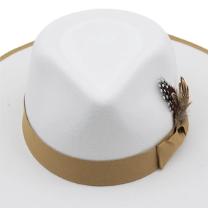 Detailed close-up of white wool fedora hat with khaki ribbon and spotted feather accents