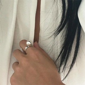 Minimalist 925 sterling silver ball ring with polished finish on model's hand