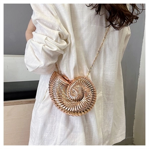 Rose gold seashell evening bag with metallic spiral texture and fine gold chain strap
