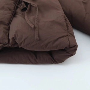 Women's cropped brown puffer jacket with thick quilting and adjustable drawstring detail