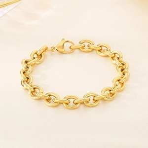 Detailed macro view of golden stainless steel chain link bracelet with lobster clasp