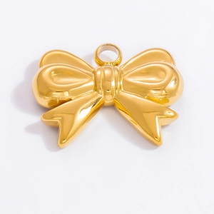 Detailed view of polished 18k gold bow pendant with small loop for DIY jewelry making