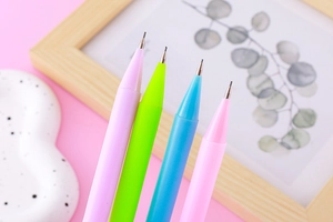 Close-up of pastel tulip mechanical pencils in various macaron colors on a desk