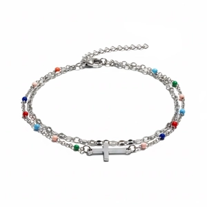 Macro detail of silver double-layered bracelet with cross pendant and colorful beads