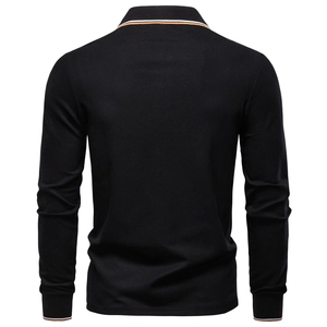 Detail of black cotton polo shirt back with orange and white striped collar and cuffs