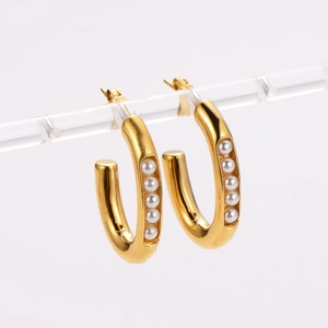 Gold C-shaped hoop earrings with embedded white pearls in a retro minimalist French design