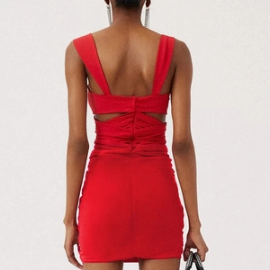 Detail of red hollowed-out swimwear with elegant 3D floral accents and cross back straps