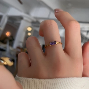 18K gold plated titanium ring with rectangular purple crystal on model finger