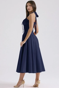 Side view of navy blue halter midi dress with floral print and slim waist design