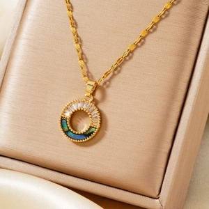Elegant gold necklace with a circular pendant featuring zircon inlay and a teal shell finish