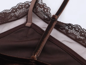 Close-up of brown velvet fabric texture with delicate lace trim and adjustable strap