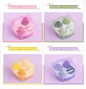 Detail of makeup sponge set in bear-shaped box showing peach, green, yellow, and purple colors