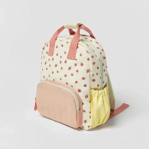 Beige cotton canvas kids backpack featuring red strawberry prints and pink accents