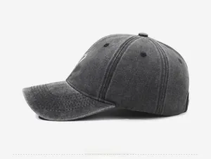 Side view of vintage washed charcoal cotton baseball cap with curved brim and eyelets