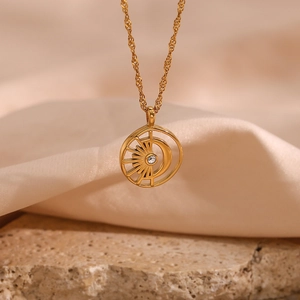 Detail of 18K gold-plated necklace with hollow sun-moon pendant on beige satin