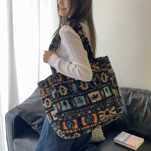 Close-up of plush tote bag with vintage geometric patterns and soft sherpa texture