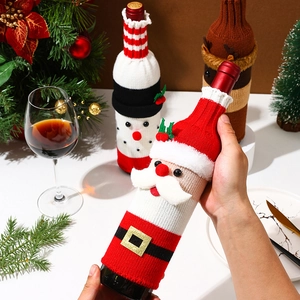 Knitted Christmas wine bottle covers featuring Santa, snowman, and reindeer designs