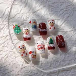 5D embossed Christmas nail stickers with festive 3D patterns on white textured paper