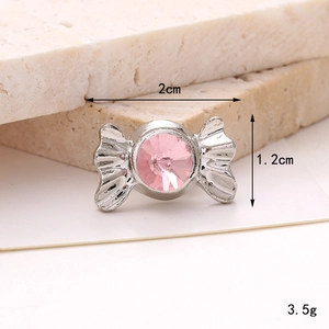 Macro detail of 2cm candy-shaped zinc alloy shoe charm with pink crystal and silver finish