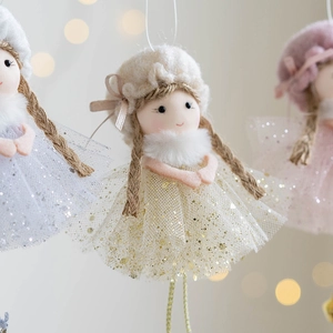 Christmas angel doll decoration with sequined mesh skirt and plush wings on soft background