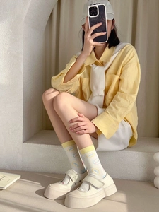 Close-up of cute cartoon bear pattern and Hello text on women's cotton mid-calf socks