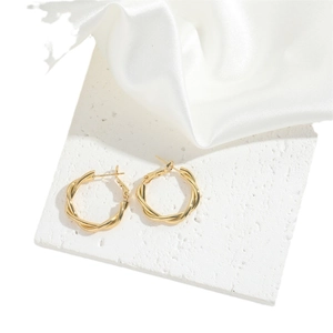 French vintage style chunky gold rope twist hoop earrings on a white stone background