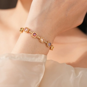 Macro view of vintage gold bracelet with colorful square-cut zircon gemstones