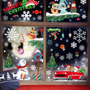 Christmas window decals with Santa, snowman and owl on glass pane for holiday decor