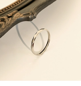 Macro detail of silver titanium steel ring with sparkling geometric faceted cutting
