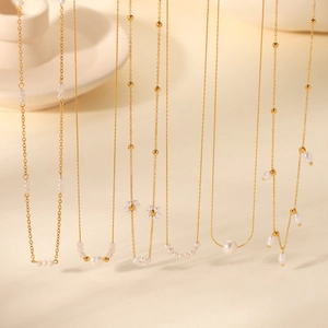 Detailed display of French vintage freshwater pearl necklaces with gold stainless steel chains
